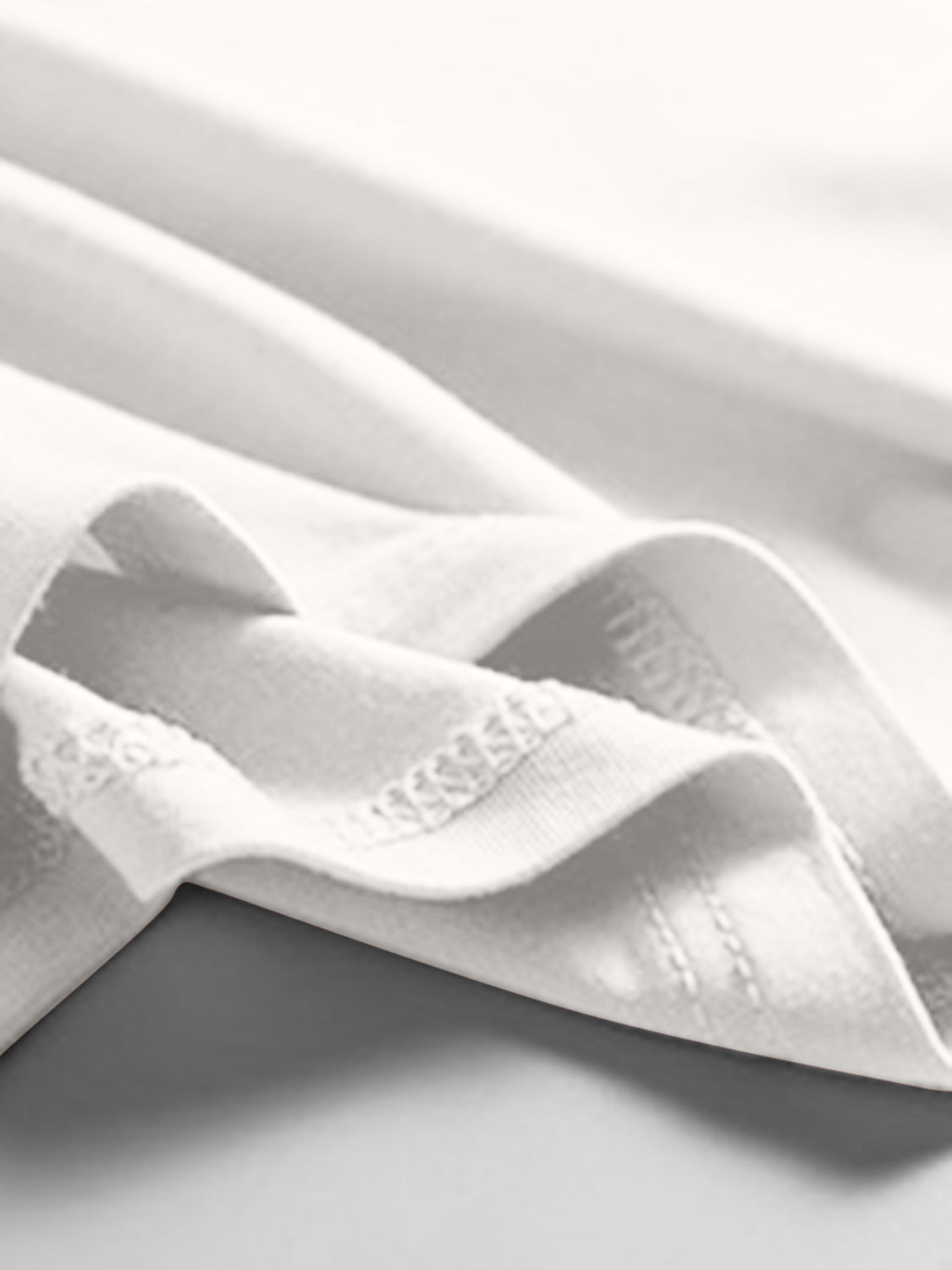 White scoop neck tank top with visible stitching detail