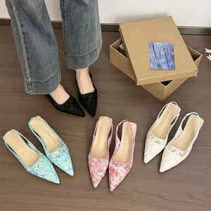 Elegant lace slingback kitten heels in black, pink, green, and white with pointed toes.