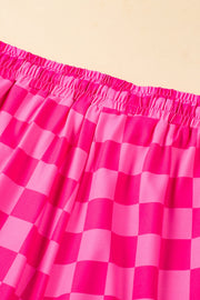 Hot pink checkerboard lounge shorts with elastic waistband