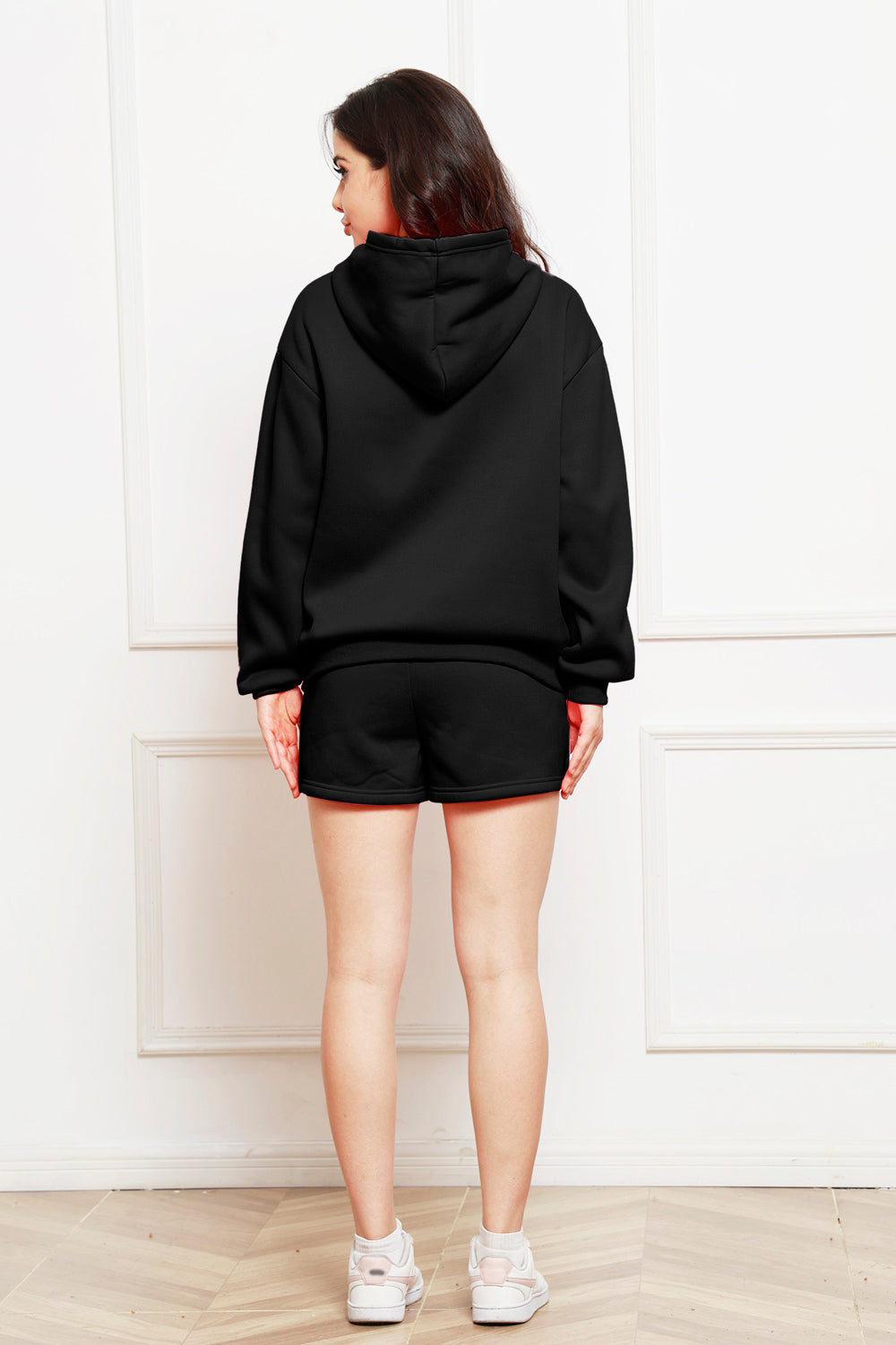 Black hooded loungewear set with shorts and a hoodie, shown from the back.