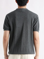 Classic short-sleeve polo shirt in grey cotton with a textured knit and button detail.