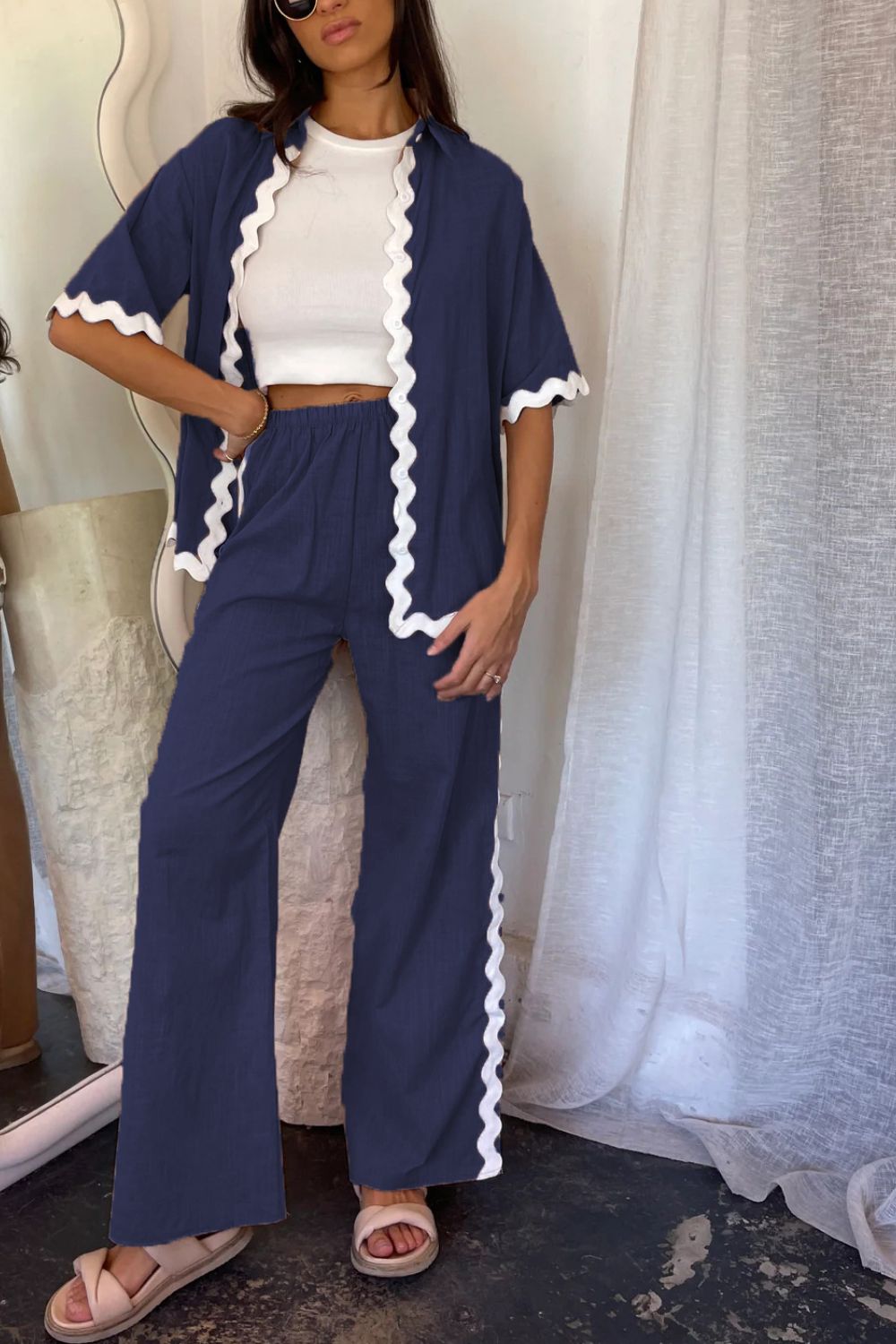 Dark blue scalloped edge co-ord set with short sleeves and wide leg pants.