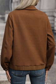 Textured chevron utility jacket in burnt umber with a zip front and collared neckline.