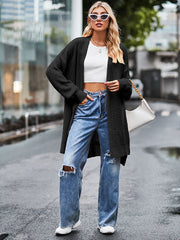 Open-stitch waffle knit duster cardigan in black, featuring a relaxed fit and long sleeves.