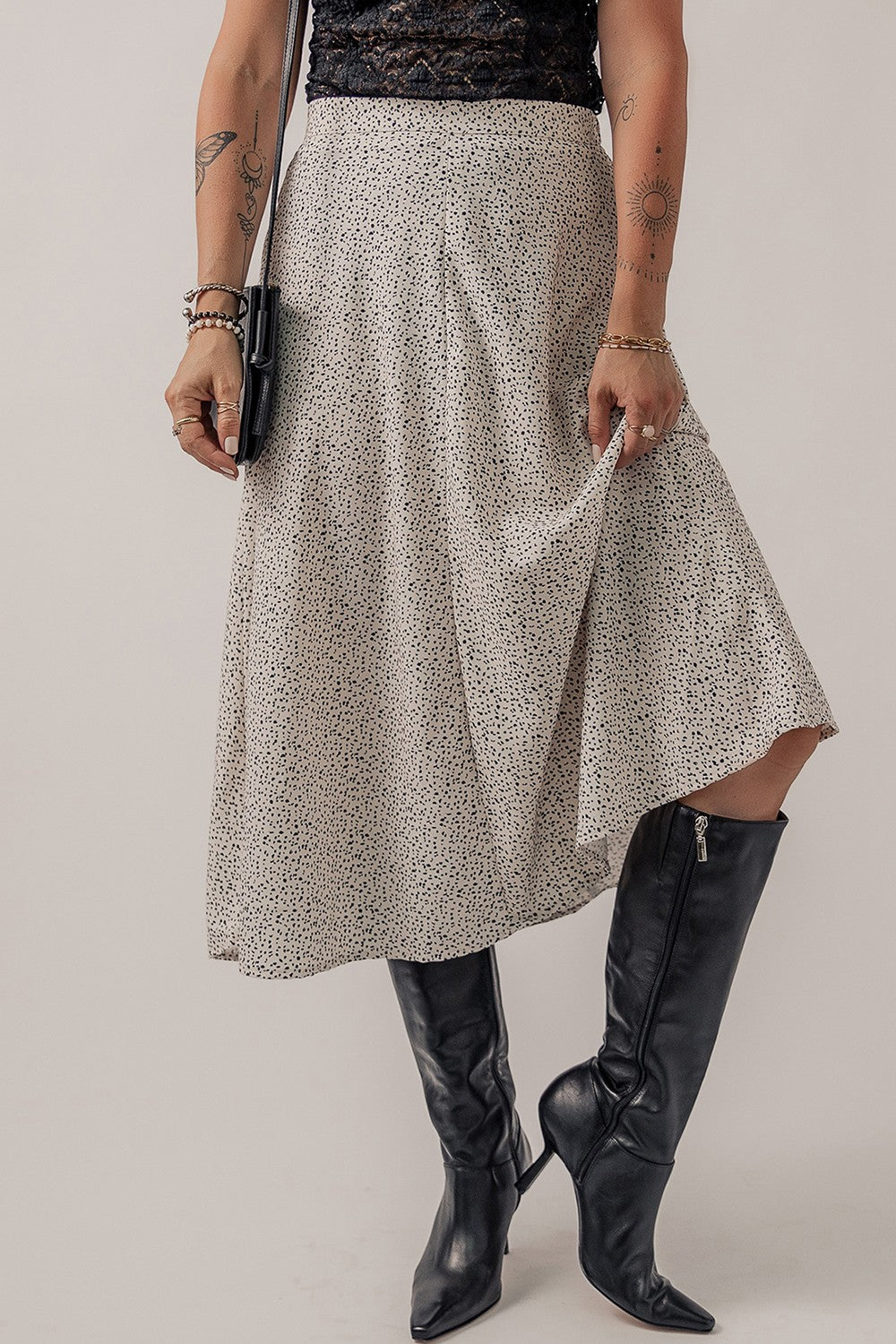 Dotted bias-cut midi skirt in heather gray, shown with black boots and a clutch.