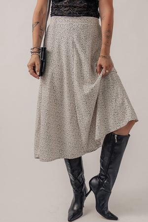 Dotted bias-cut midi skirt in heather gray, shown with black boots and a clutch.