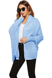 Light blue acrylic cocoon knit shawl collar cardigan with batwing sleeves.