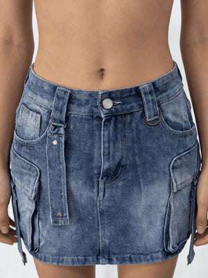 Plus size dark blue washed denim cargo skirt with button closure and utility pockets.