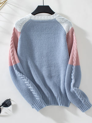 Chevron cable knit sweater in pastel blue, blush pink, and white colorblock with cable knit sleeves.