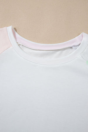 White loungewear set with pink and mint green colorblock sleeves and neckline detail.