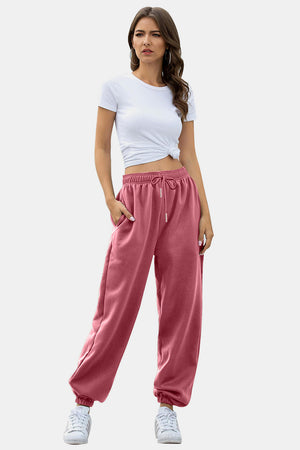 Dusty Pink sweatpants with drawstring waist and gathered cuffs.