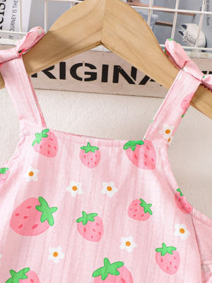 Pink strawberry print cami with bow shoulder straps and ruffled trim.