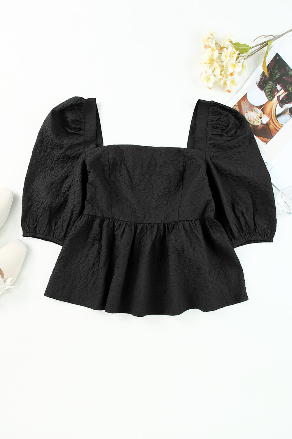 Black textured peplum blouse with square neck and petal puff sleeves