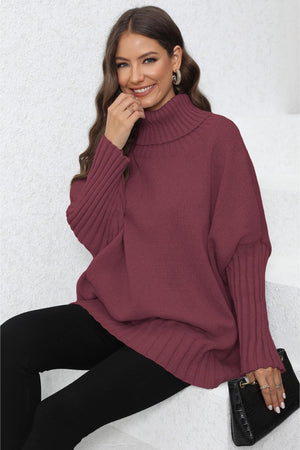 Burgundy ribbed knit turtleneck sweater with batwing sleeves and cuffed wrists.