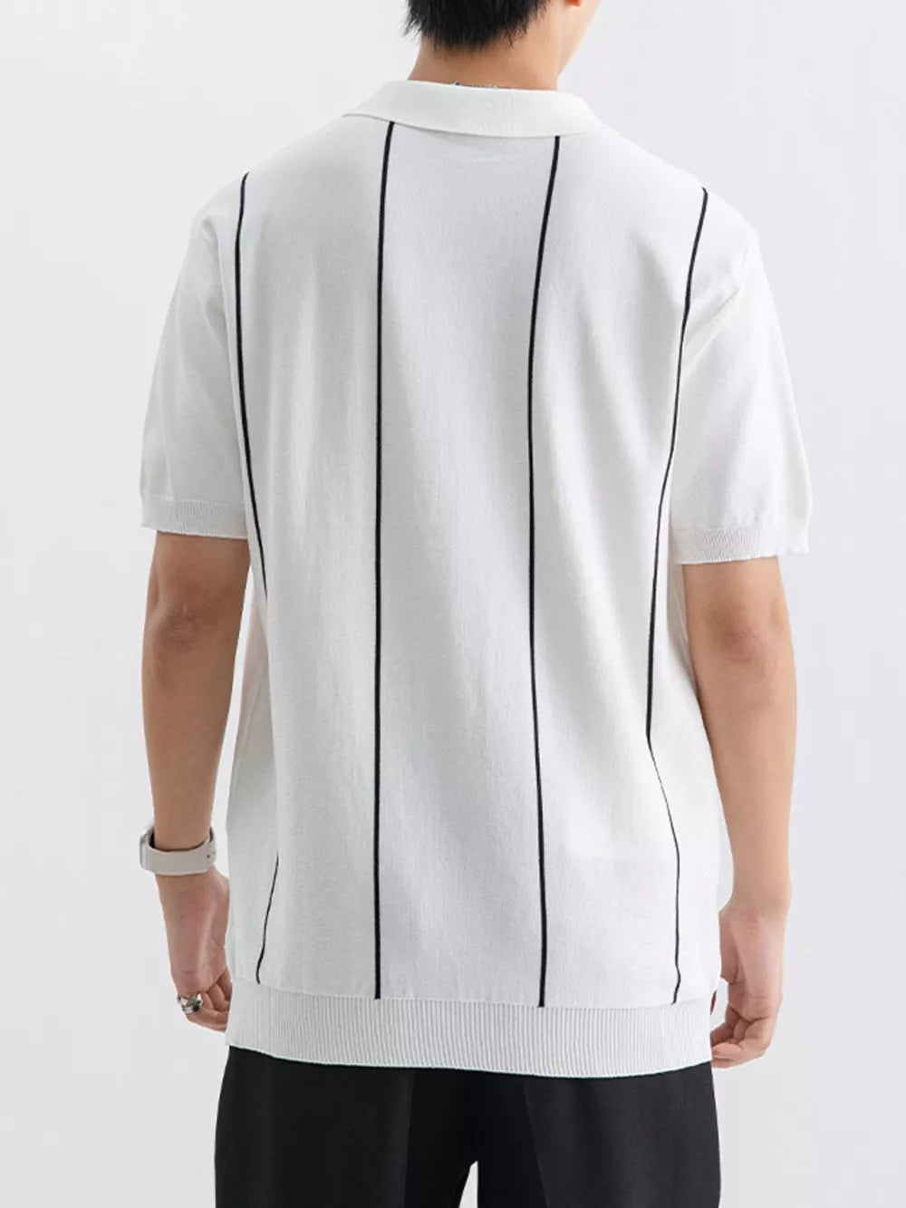White knit polo shirt with vertical black stripes and ribbed hem.