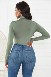 Sculpted turtleneck bodysuit in Army Green with long sleeves, paired with blue denim jeans.