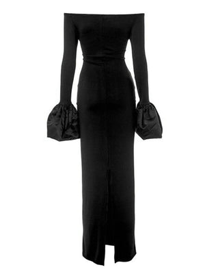 Black off-shoulder maxi dress with dramatic gathered sleeve cuffs and a thigh-high slit.