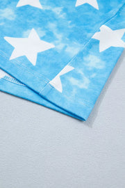 Patriotic t-shirt with white stars on a blue tie-dye background, showing hem detail.
