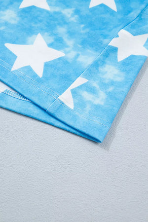 Patriotic t-shirt with white stars on a blue tie-dye background, showing hem detail.