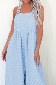 Light blue textured checkered button-strap palazzo jumpsuit with square neckline.