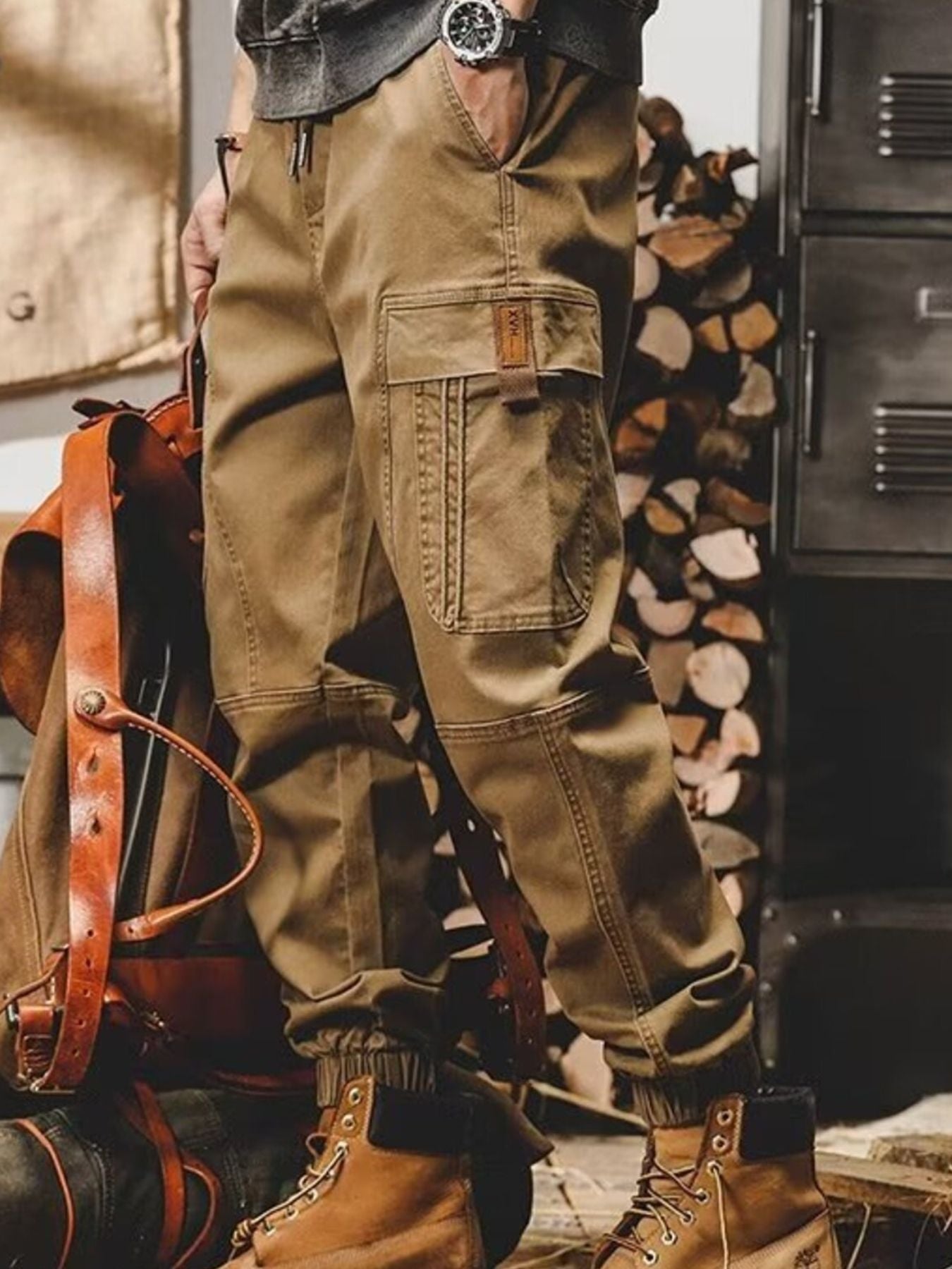 Khaki relaxed fit cargo pants with multiple pockets and elastic cuffs.