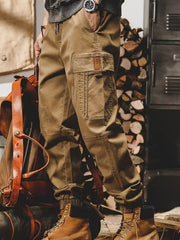Khaki relaxed fit cargo pants with multiple pockets and elastic cuffs.