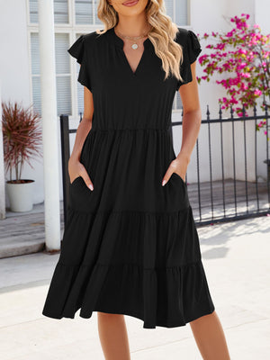Black midi dress with ruffled short sleeves, tiered skirt, and pockets.