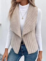 Cozy open front fleece vest in beige with a shawl collar, ribbed texture, and open sides.