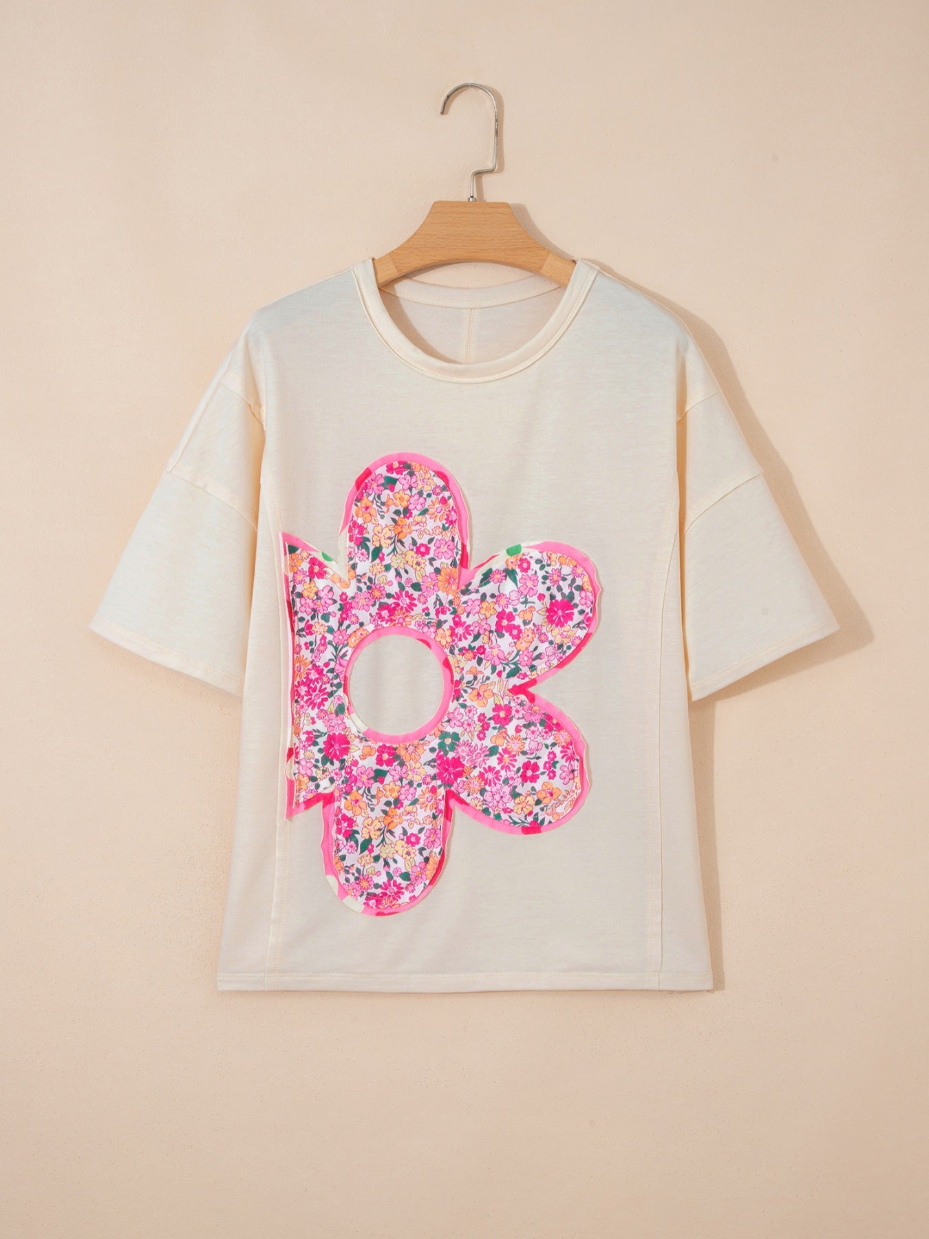 Cream cotton t-shirt with oversized floral chenille patch and crew neck.