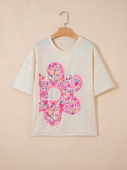 Cream cotton t-shirt with oversized floral chenille patch and crew neck.