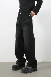 Faded black baggy denim trousers with a relaxed fit and casual styling.