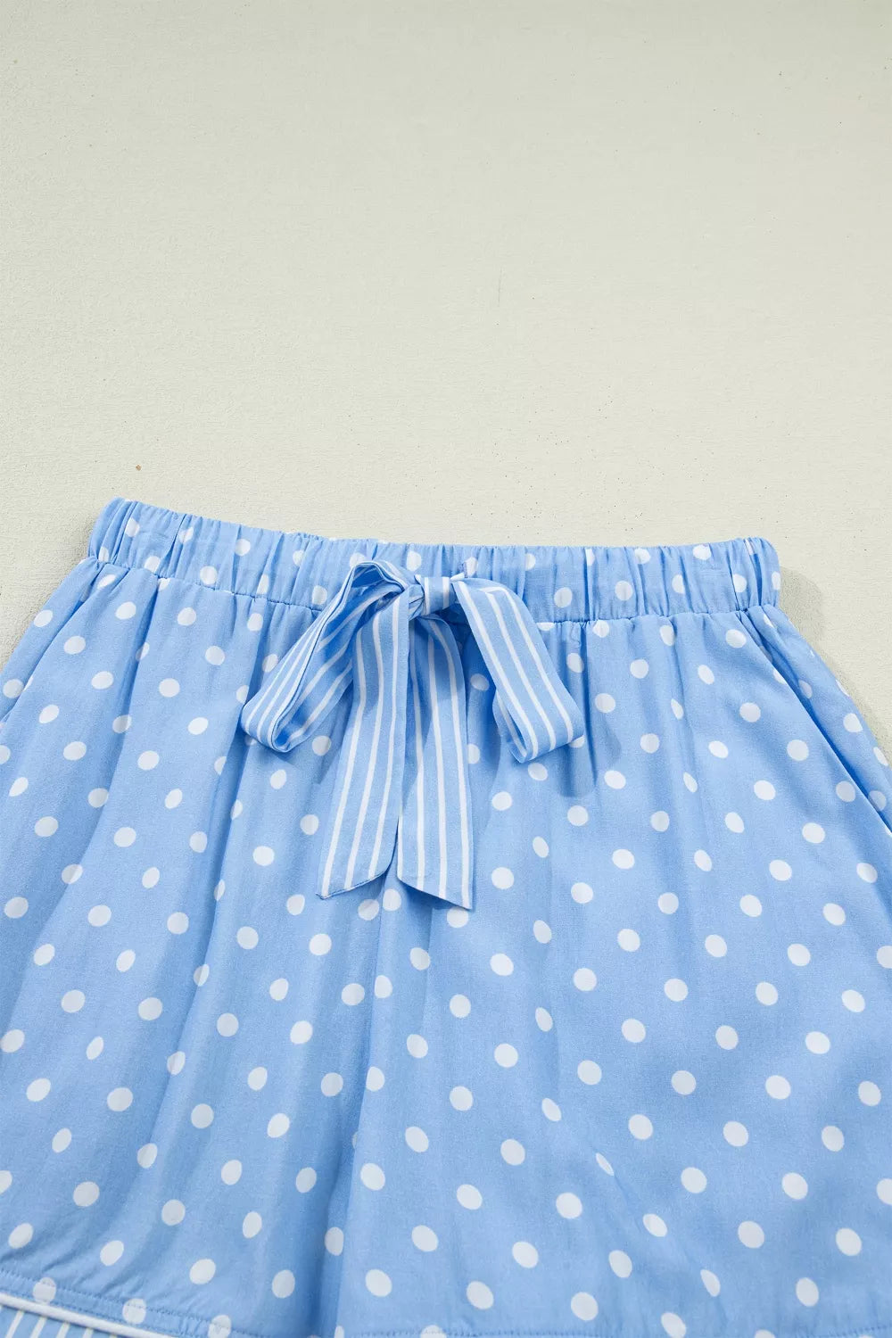 Blue polka dot viscose pajama shorts with drawstring and white stripe tie.