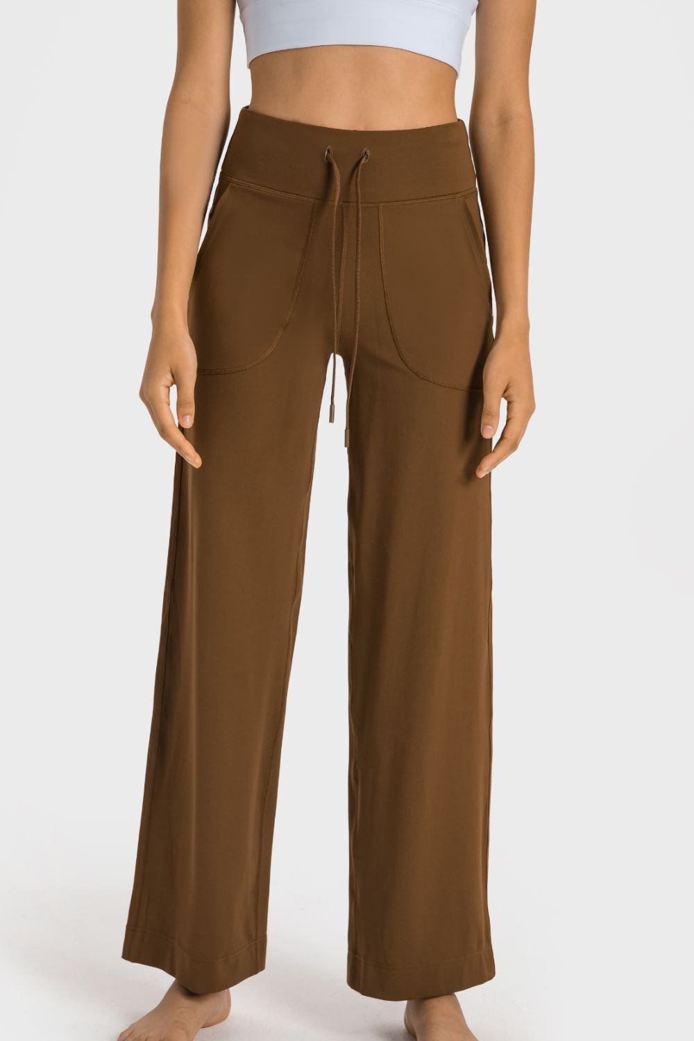 Brown wide-leg jogger trousers with drawstring waist and utility pockets.