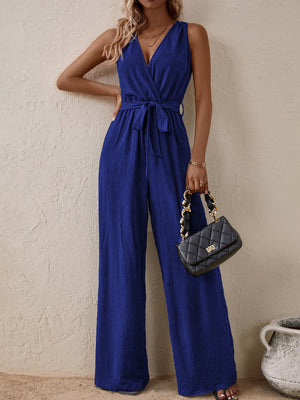 Textured wrap-front wide-leg jumpsuit in indigo with a tie waist and V-neck.