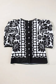 Black floral puff sleeve blouse with button back and decorative trim.