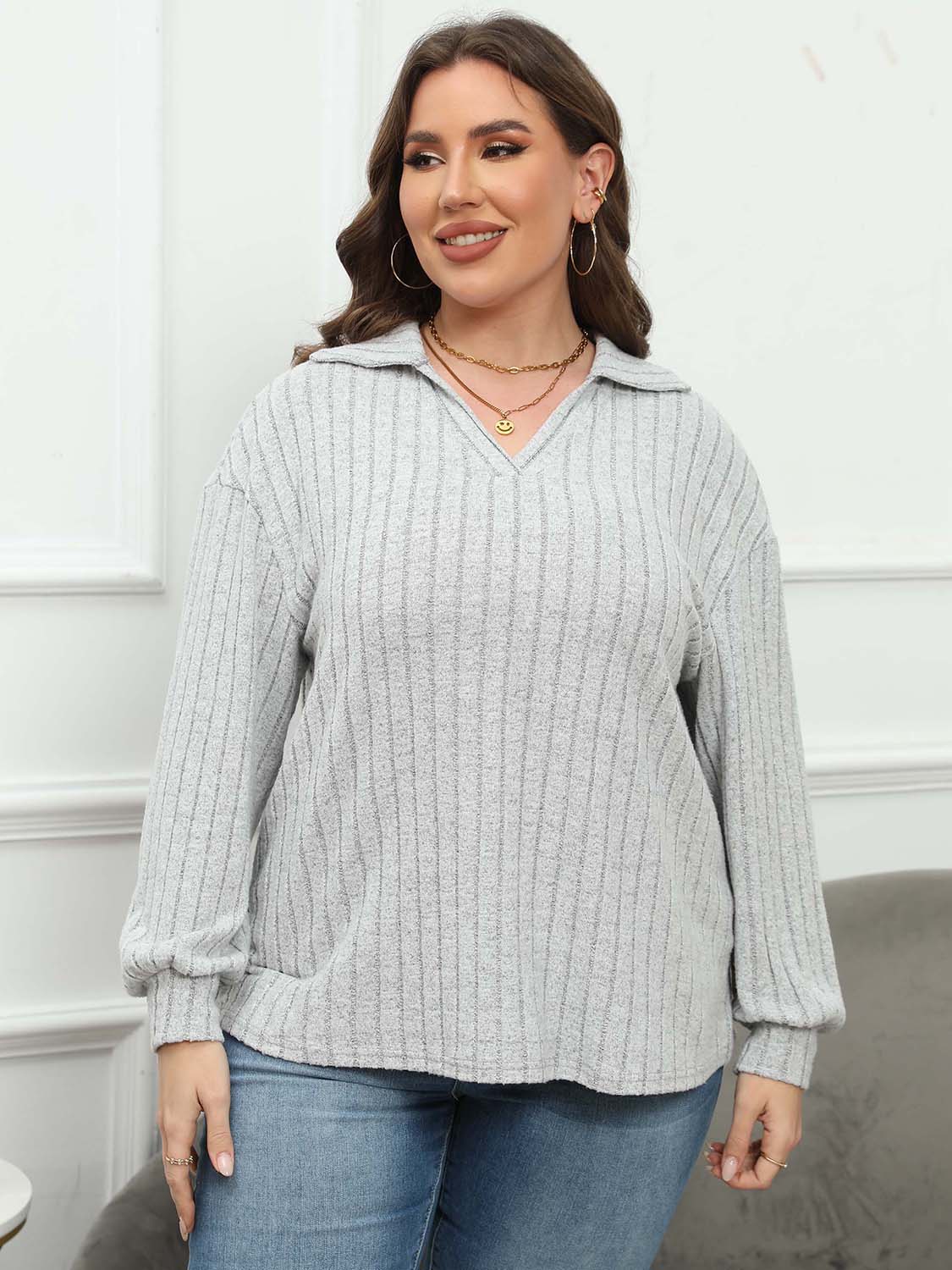 Relaxed ribbed polo top in grey with a collared neckline and long sleeves.