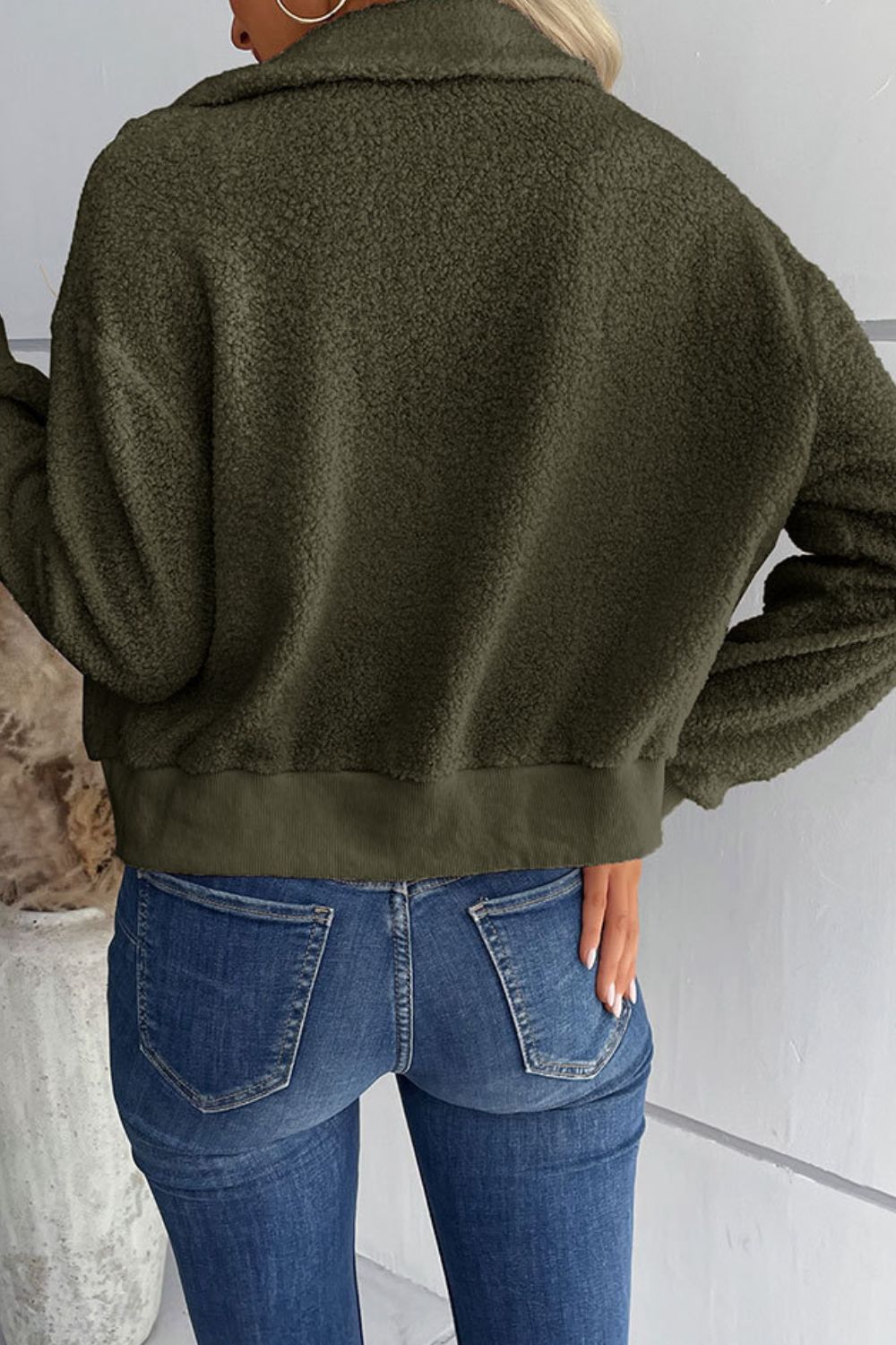 Green teddy fleece bomber jacket with collared neck and ribbed hem.
