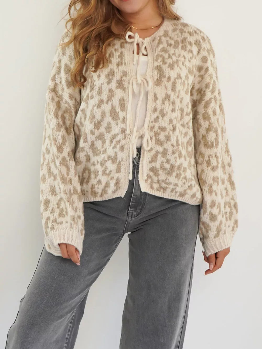 Khaki leopard print tie-front cropped cardigan with long sleeves.