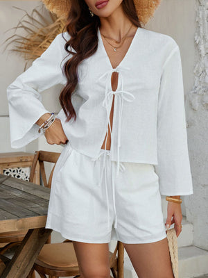 White linen tie-front top with bell sleeves and matching drawstring shorts.