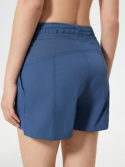 Dusty blue utility shorts with drawstring waist and textured waistband detail.