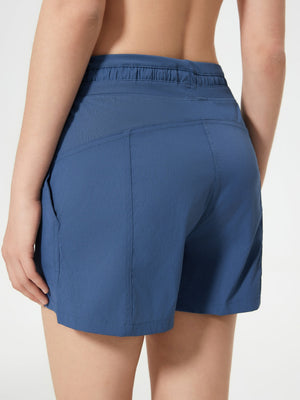 Dusty blue utility shorts with drawstring waist and textured waistband detail.