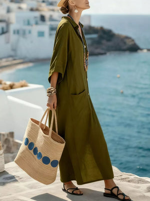 Olive green button-front maxi dress with 3/4 sleeves and pockets, styled with a straw tote bag.