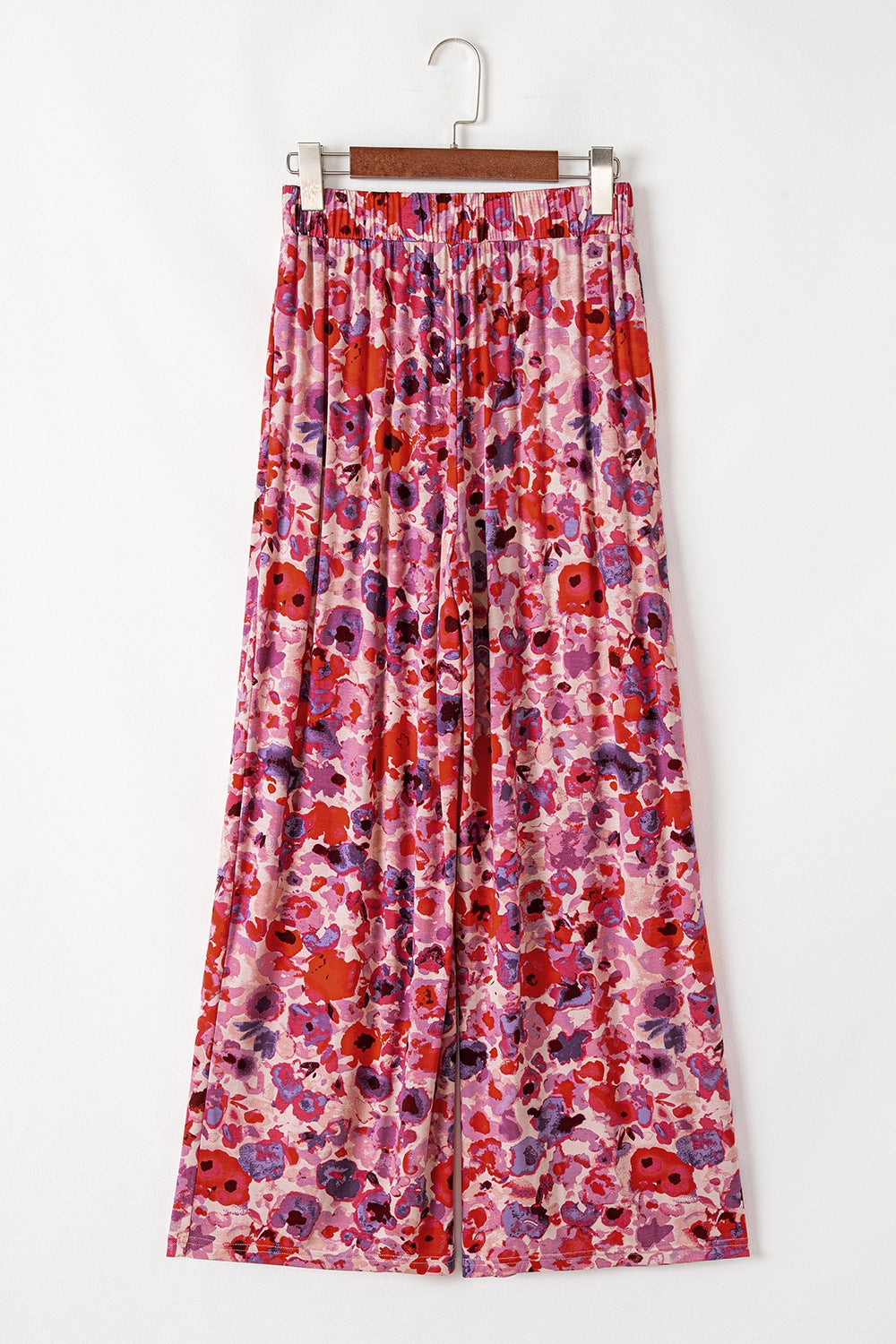 Painterly floral palazzo trousers in strawberry pink with a vibrant, colorful bloom print and wide leg.