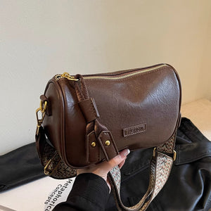 Brown textured pu leather crossbody bag with a patterned strap and gold hardware.