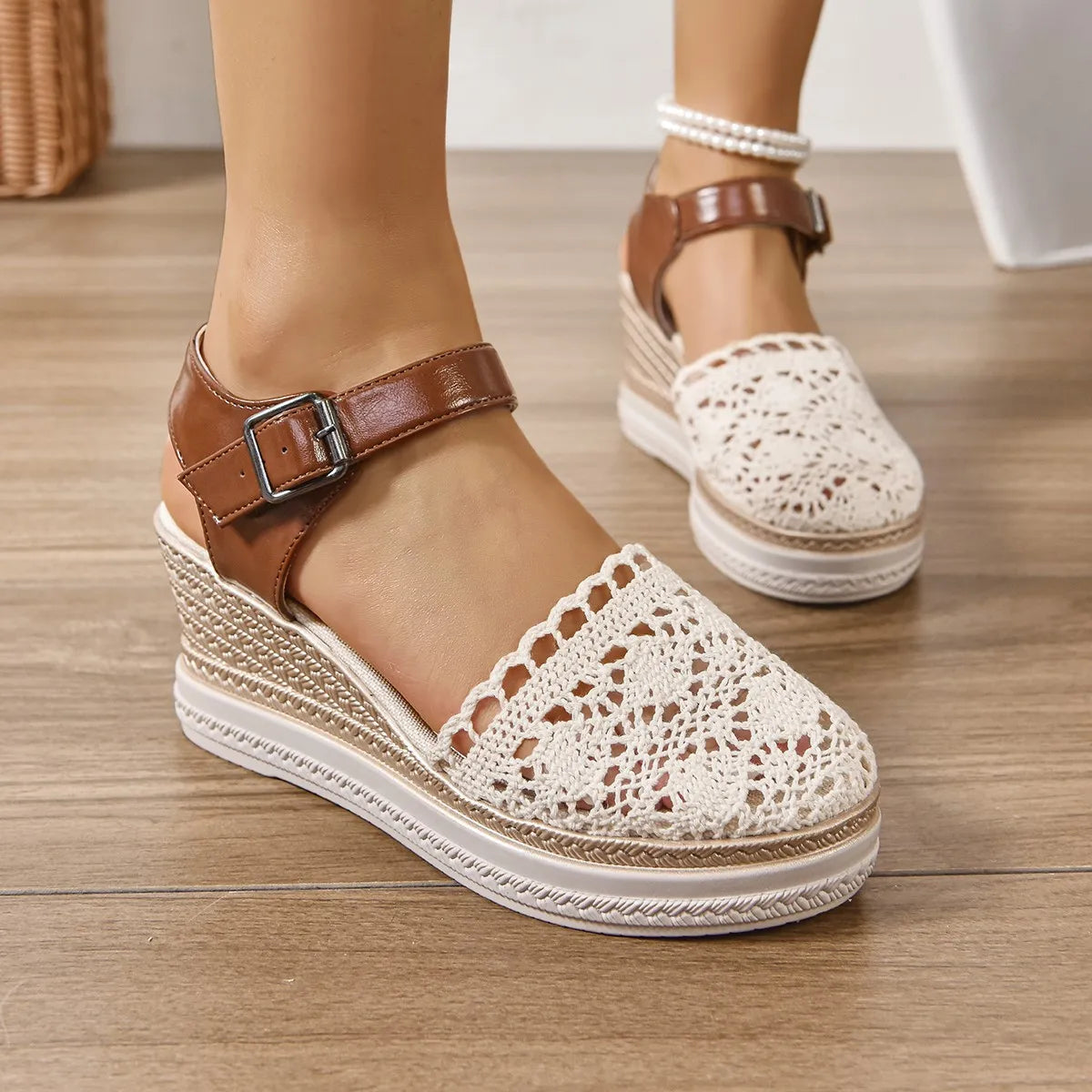 Beige crochet and leather wedge ankle strap sandals with buckle closure.