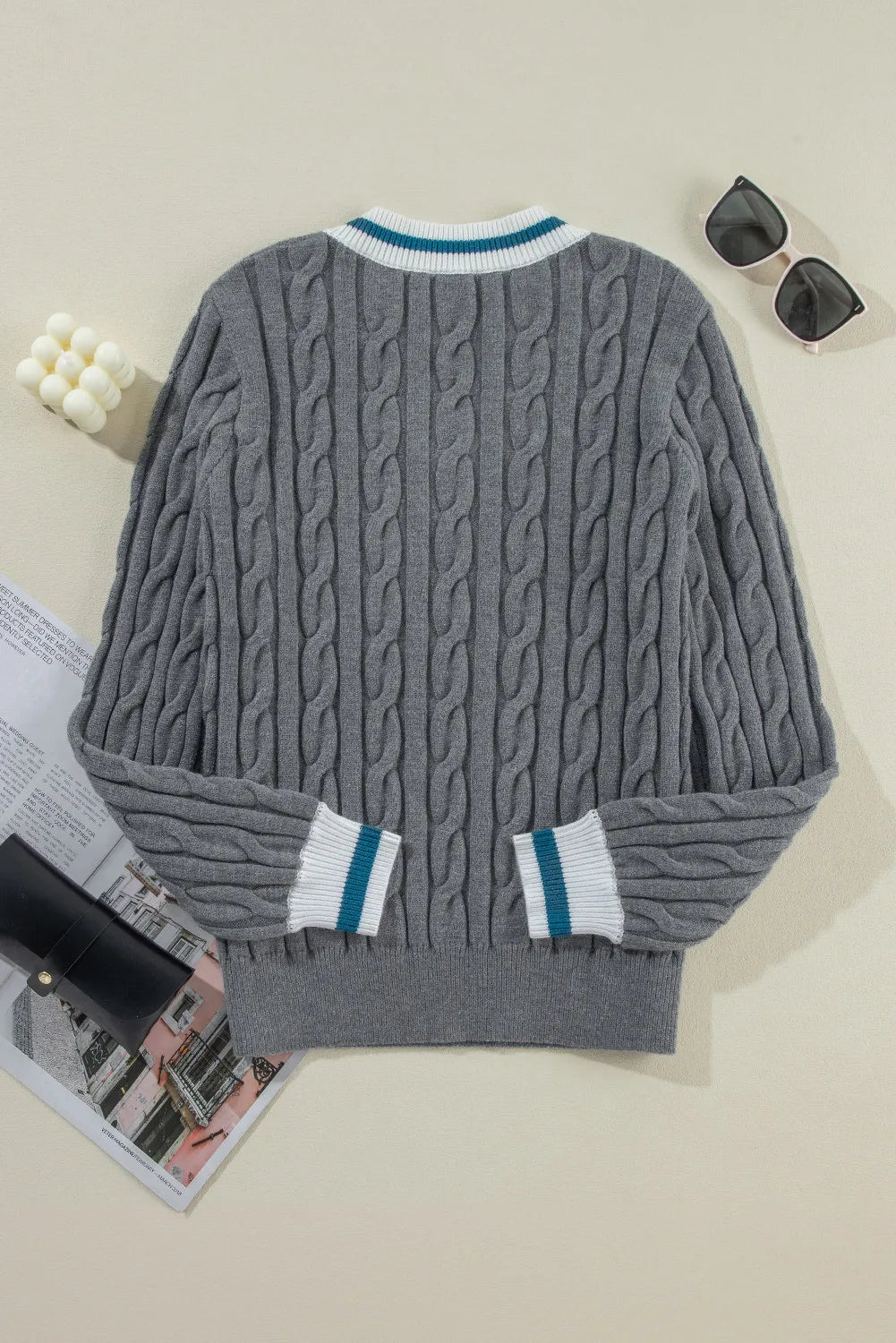 Dark gray cable knit sweater with varsity trim neckline and cuffs.
