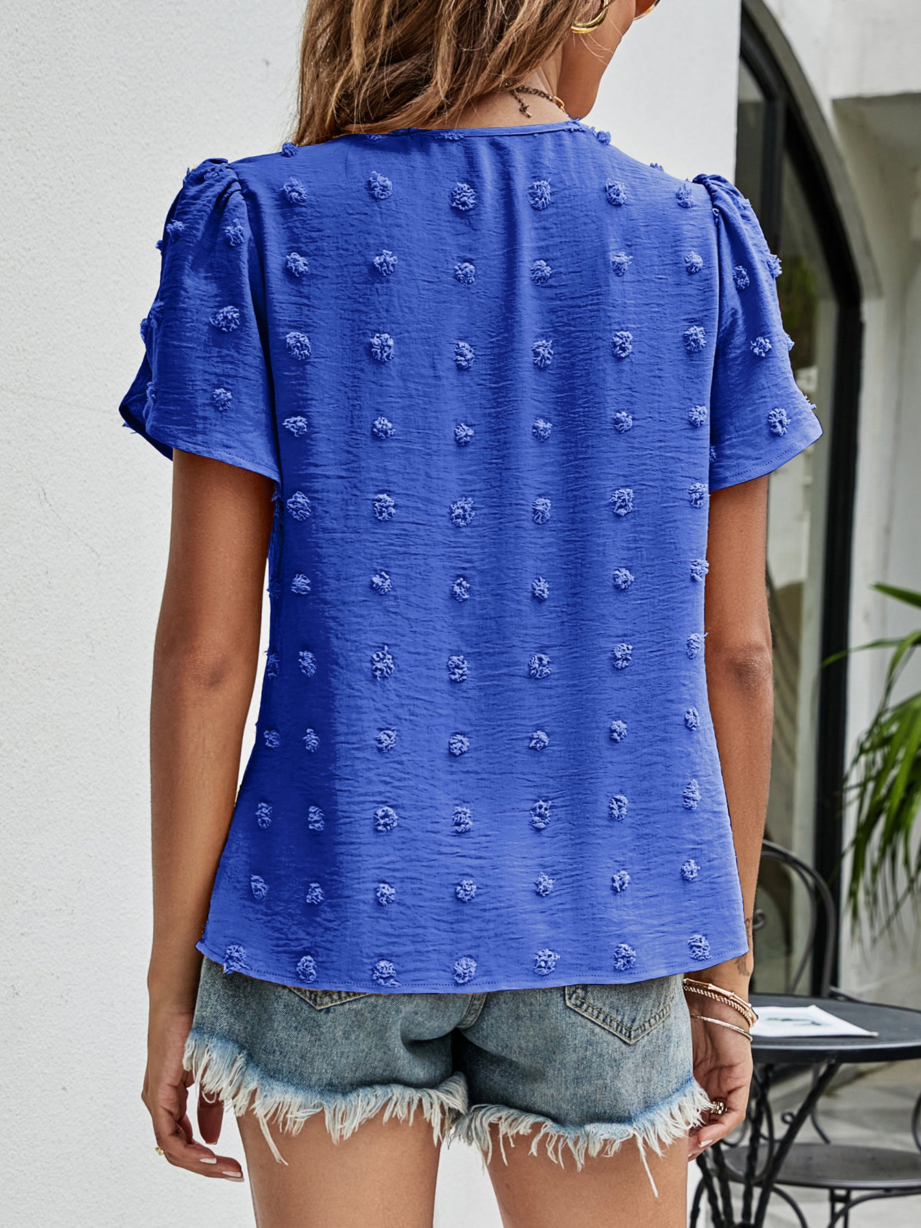 Royal blue textured puff sleeve blouse with dot pattern and short sleeves.