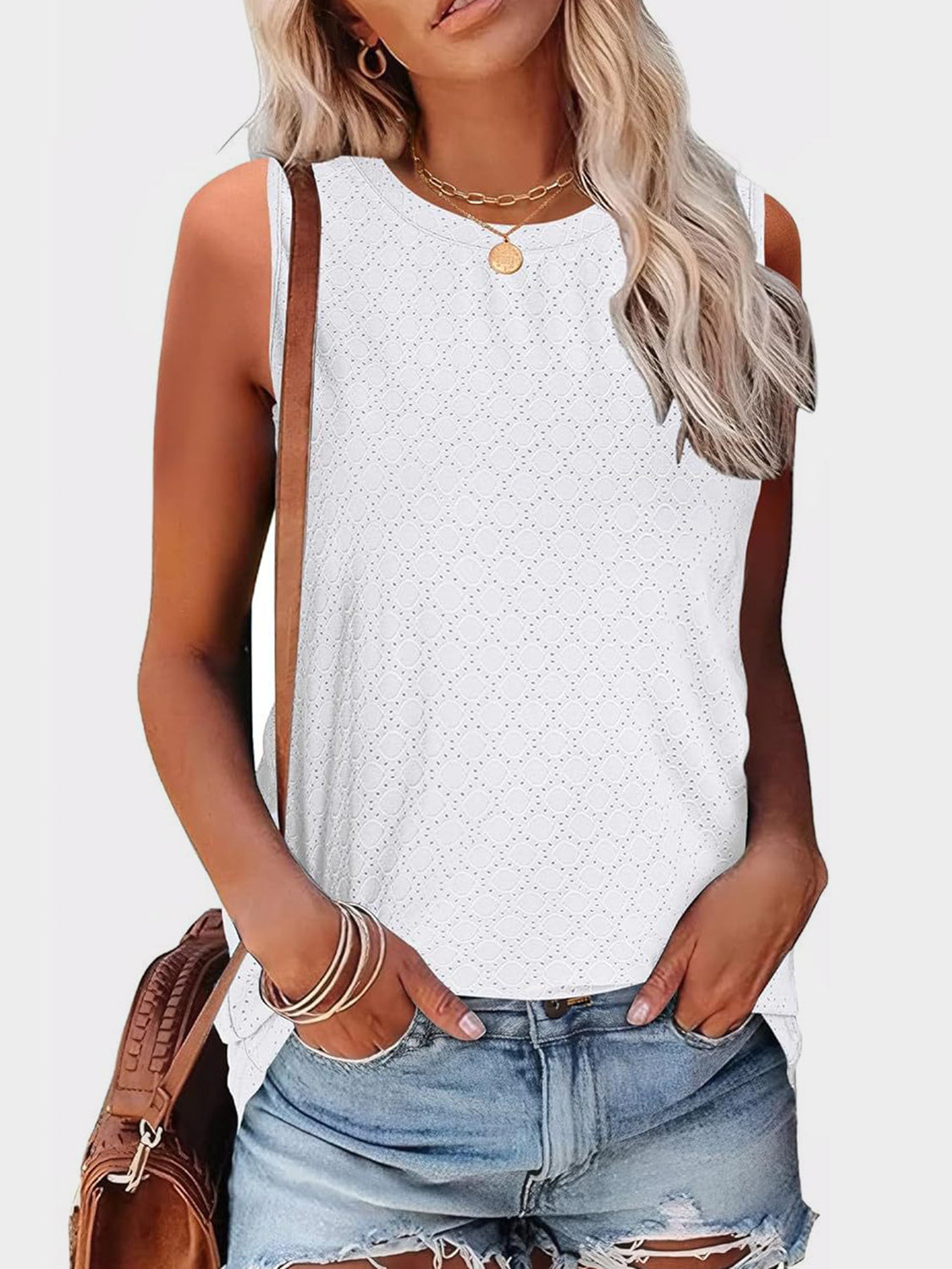 White textured sleeveless shell top with eyelet pattern and round neckline