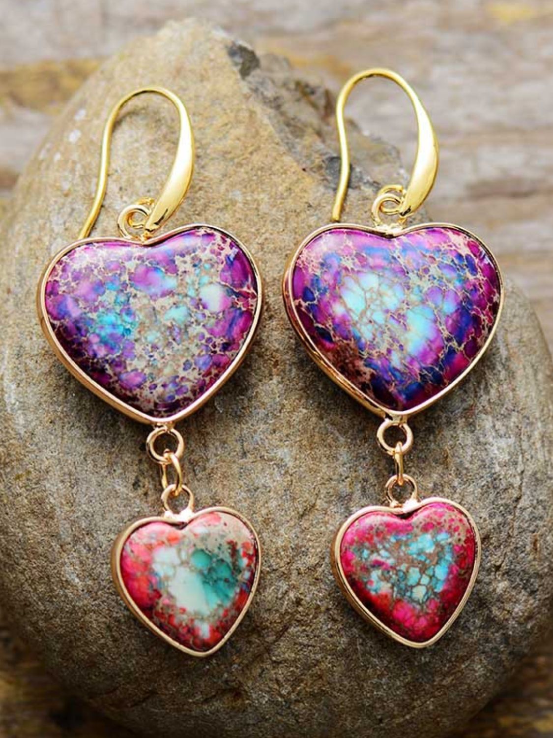 Heart stone cascade earrings in electric purple with gold hooks and dangling smaller hearts.