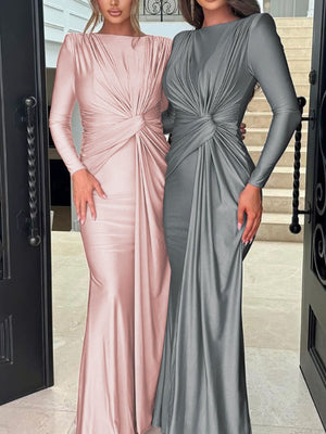 Ruched knot front maxi dress in pink and gray with long sleeves and a draped skirt.